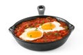 Mexican breakfast: Huevos rancheros in iron frying pan