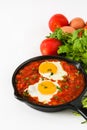 Mexican breakfast: Huevos rancheros in iron frying pan isolated Royalty Free Stock Photo