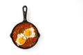 Mexican breakfast: Huevos rancheros in iron frying pan isolated Royalty Free Stock Photo