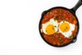 Mexican breakfast: Huevos rancheros in iron frying pan isolated Royalty Free Stock Photo