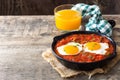 Mexican breakfast: Huevos rancheros in iron frying pan on wood Royalty Free Stock Photo