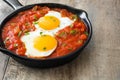 Mexican breakfast: Huevos rancheros in iron frying pan on wood Royalty Free Stock Photo