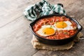 Mexican breakfast: Huevos rancheros in iron frying pan on wood Royalty Free Stock Photo