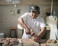 Mexican butcher cutting chicken