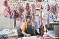 Mexican butcher with hanging pork