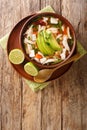 Mexican caldo tlalpeno soup  made with homemade chicken stock  a chipotle tomato base  and shredded chicken closeup on the table. Royalty Free Stock Photo