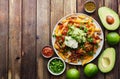 Mexican carne asada fries on wooden table top Royalty Free Stock Photo