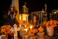 Mexican Catrina and Catrin at a cementery