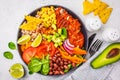 Mexican chicken burrito bowl with rice, beans, tomato, avocado,corn and spinach, top view. Mexican cuisine food concept Royalty Free Stock Photo