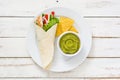 Mexican chicken fajitas with peppers lettuce and onion on a plate and white wooden background Royalty Free Stock Photo