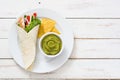 Mexican chicken fajitas with peppers lettuce and onion on a plate and white wooden background Royalty Free Stock Photo