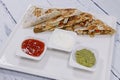 Mexican chicken quesadilla sandwiches and typical condiments