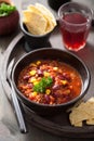 Mexican chili con carne in black bowl with tortilla Royalty Free Stock Photo