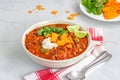 Mexican Chilli in a Bowl Top Down Photo, Garnish with Soured Cream, Cilantro and Lemon