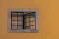 Mexican classic colonial style window with yellow wall Royalty Free Stock Photo