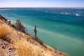 Mexican coastal landscape with hillside in arid terrain with cactus, sea in background Royalty Free Stock Photo