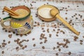 Mexican coffee with cinnamon in cup with Mexican decoration on white wooden table with organic coffee grain and natural bowl with Royalty Free Stock Photo