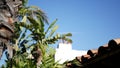 Mexican colonial style suburban, hispanic house exterior, green lush garden, San Diego, California USA. Mediterranean terracotta