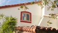 Mexican colonial style suburban, hispanic house exterior, green lush garden, San Diego, California USA. Mediterranean terracotta