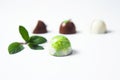 Mexican Colorful chocolate candy bonbons with mint leaves, cinnamon and coffee beans on white background