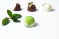 Mexican Colorful chocolate candy bonbons with mint leaves, cinnamon and coffee beans on white background