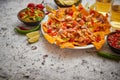 Mexican corn nacho spicy chips served with melted cheese