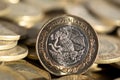 Mexican currency in the foreground, with many more coins in the background, macro, Horizontal