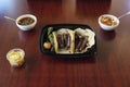 Mexican delicious beef tacos with roasted jalapeno and onion in a plastic container with salsas