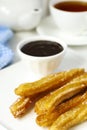 Mexican dessert churros with chocolate sauce Royalty Free Stock Photo