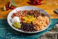 Mexican dish of a barbacoa burrito bowl, meat rice black beans sour cream guacamole and vegetables