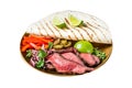 Mexican fajitas for grilled beef steak and vegetables. Isolated on white background. Top view. Royalty Free Stock Photo