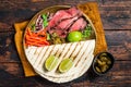 Mexican fajitas for grilled beef steak and vegetables. Wooden background. top view Royalty Free Stock Photo