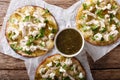 Mexican fast food: fried tortilla with chicken, cheese and green