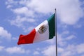 Mexican flag in a blue sky with clouds, mexico city I Royalty Free Stock Photo
