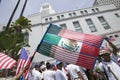 Mexican flag is superimposed over American flag in front of City Hall, Los Angeles, while hundreds of thousands of immigrants part