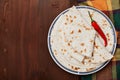 Mexican flatbread tortilla in plate on wooden table