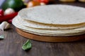 Mexican flatbread tortilla on wooden background.