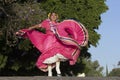 A Mexican folk dancer wearing traditional costume