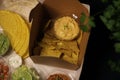 Mexican food box with nachos, guacamole, chilli