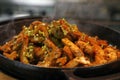 mexican food, chicken fajitas serving on a hot smoking sizzling plate with sour cream, guacamole, tomato salsa and tortilla bread Royalty Free Stock Photo