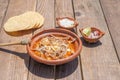 Mexican food dish. pozole with toasts, avocado and onion