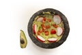 Mexican avocado green sauce called guacamole garnished with tomato, radish, coriander, onion