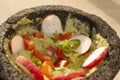 Mexican avocado green sauce called guacamole garnished with tomato, radish, coriander, onion Royalty Free Stock Photo