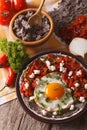 Mexican food: huevos rancheros close-up on the table. vertical Royalty Free Stock Photo