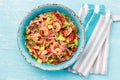 MEXICAN FOOD. Mexican shrimps ceviche sebiche with tomatoes and avocado in blue bowl, wooden blue background. Top view Royalty Free Stock Photo