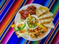 Mexican food mix colorful background, guacamole, cochinita pibil, flautas and quesadilla. Royalty Free Stock Photo