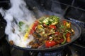 mexican food smoking chicken and beef fajitas on hot sizzling plate with fire and smoke Royalty Free Stock Photo