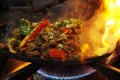 mexican food smoking chicken and beef fajitas on sizzling plate with fire and smoke Royalty Free Stock Photo