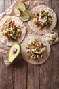 Mexican food: tortilla with carnitas, onions and avocado. Vertical top view Royalty Free Stock Photo