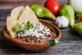 Mexican fried beans called Frijoles Refritos, plate of black beans on a wooden table in Mexico Royalty Free Stock Photo